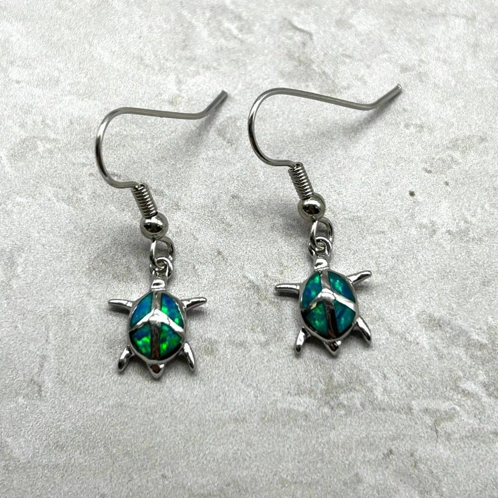 Ocean Dreams Blue Turtle Dangle Earrings: Ocean Dreams Blue Turtle Dangle Earrings Each turtle is delicately suspended, allowing them to sway gently with your every movement, adding a playful elegance to your ensemble. Whether you're