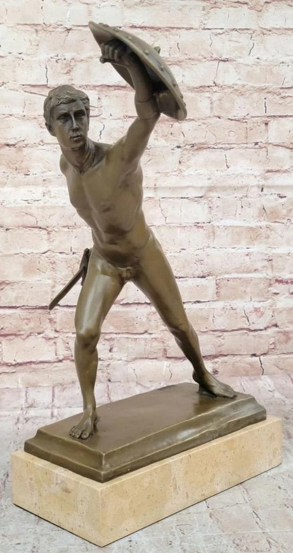 Defending Roman Gladiator Inspired Bronze Statue - 17" x 21": Defending Roman Gladiator Inspired Bronze Statue - 17" x 21" Step into the past with this captivating bronze sculpture depicting a nude gladiator training under the guidance of a seasoned ins