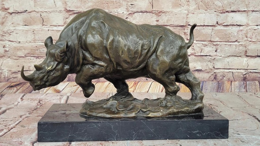 Bronze Rhinoceros Sculpture by Milo - 9" x 13": Bronze Rhinoceros Sculpture by Milo - 9" x 13" This striking bronze sculpture by Milo captures the strength and majesty of the rhinoceros with remarkable detail. Expertly crafted using the los