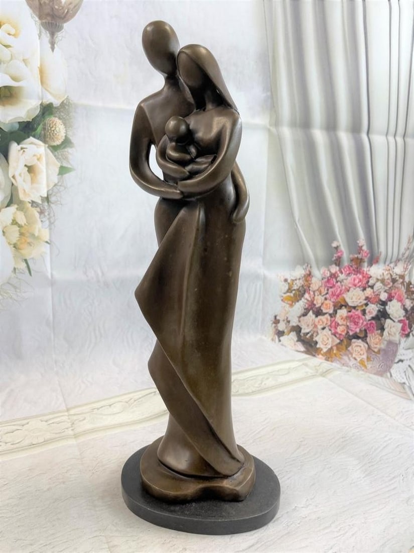 Loving Family Bronze Sculpture: Loving Family Bronze Sculpture This bronze sculpture honors the union of marriage between man and woman celebrating their love for a lifetime. Within their embrace, sleeps their newborn c