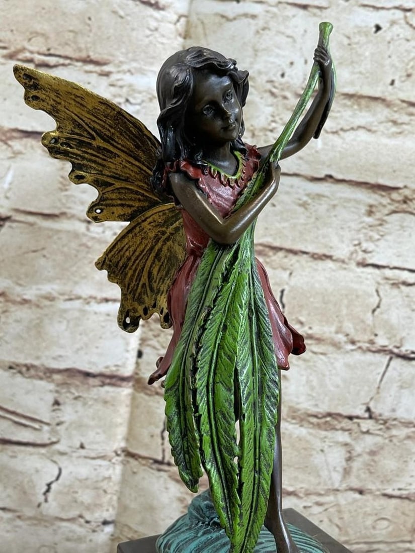 Baby Angel Bronze Sculpture: Baby Angel Bronze Sculpture Daydreamers will fall in love with this daydreaming fairy. She sits on a rock and gazes out into the mystical land around her. She dangles her legs over the si