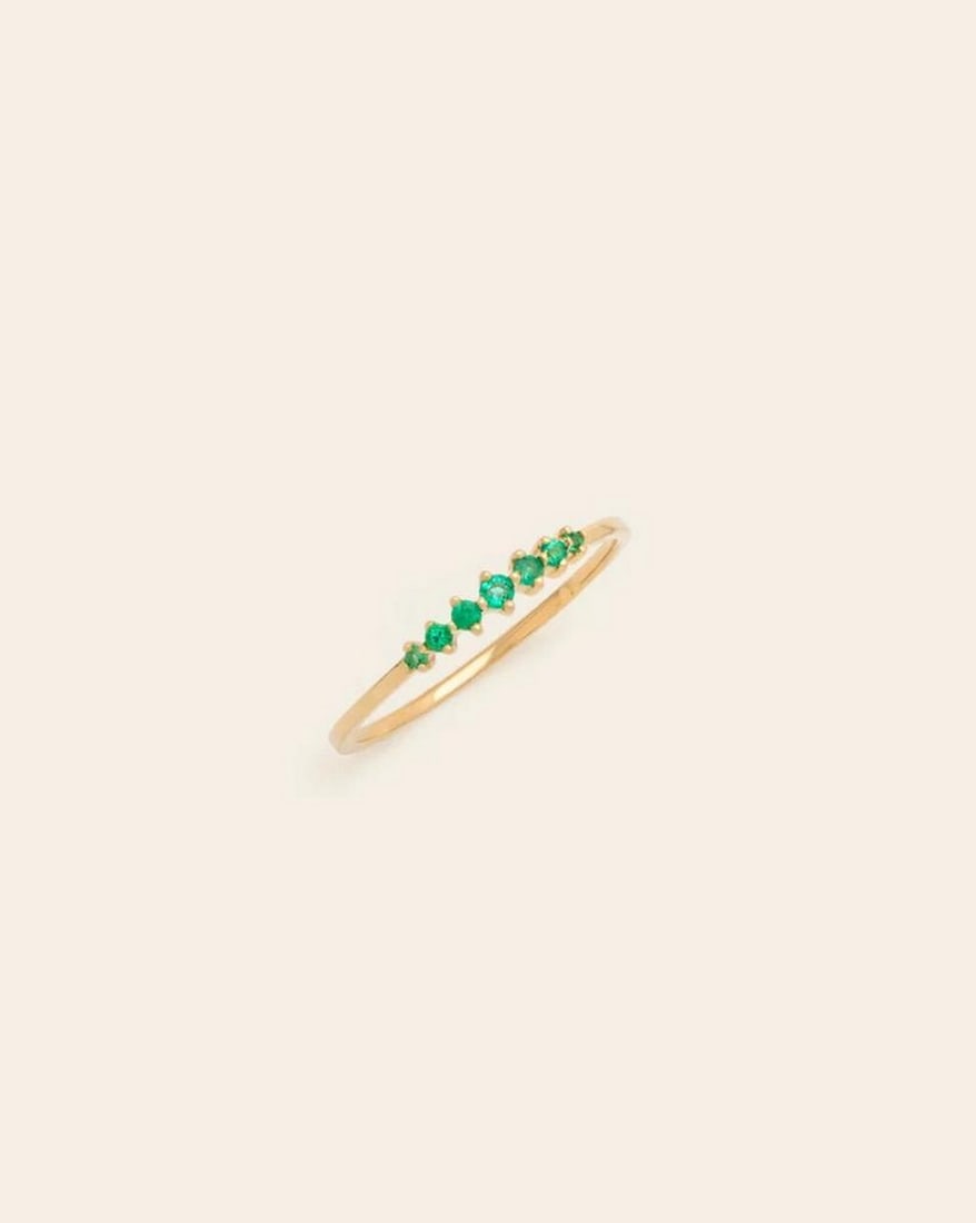 14k Solid Gold Prong Set Emerald Band: 14k Solid Gold Prong Set Emerald Band This 14K solid gold band showcases a row of vibrant emeralds, each securely held in a classic prong setting. The rich green gemstones are beautifully