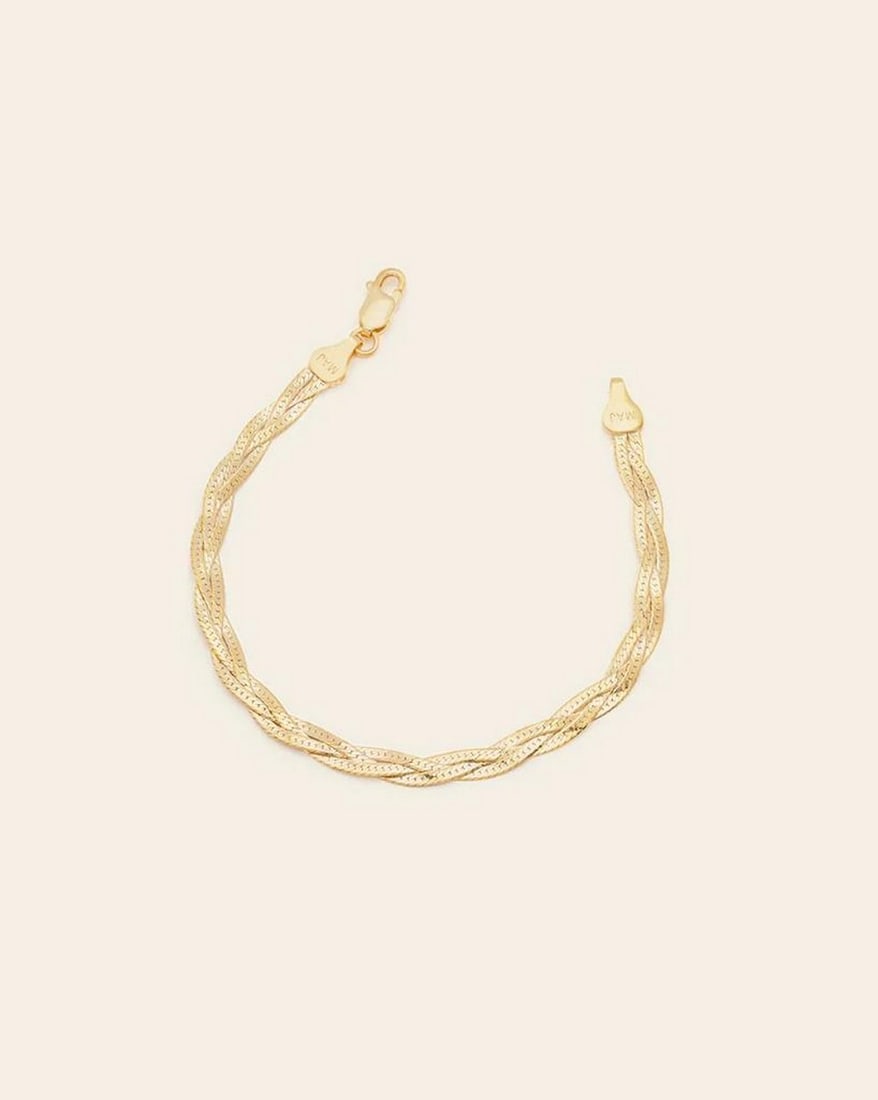 Gold Vermeil Braided Herringbone Bracelet: Gold Vermeil Braided Herringbone Bracelet A modern twist on a classic! Three herringbone chains are delicately intertwined to create a golden braid that dazzles on any wrist. The perfect,