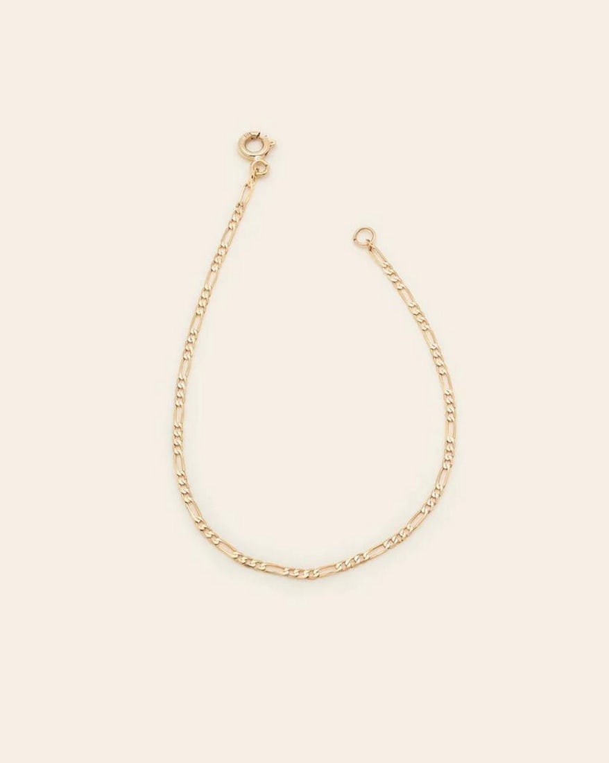10k Solid Gold Figaro Chain Anklet: 10k Solid Gold Figaro Chain Anklet The Figaro Chain features a timeless design with understated elegance. This versatile anklet complements any look, adding the perfect touch of shine. Solid gold