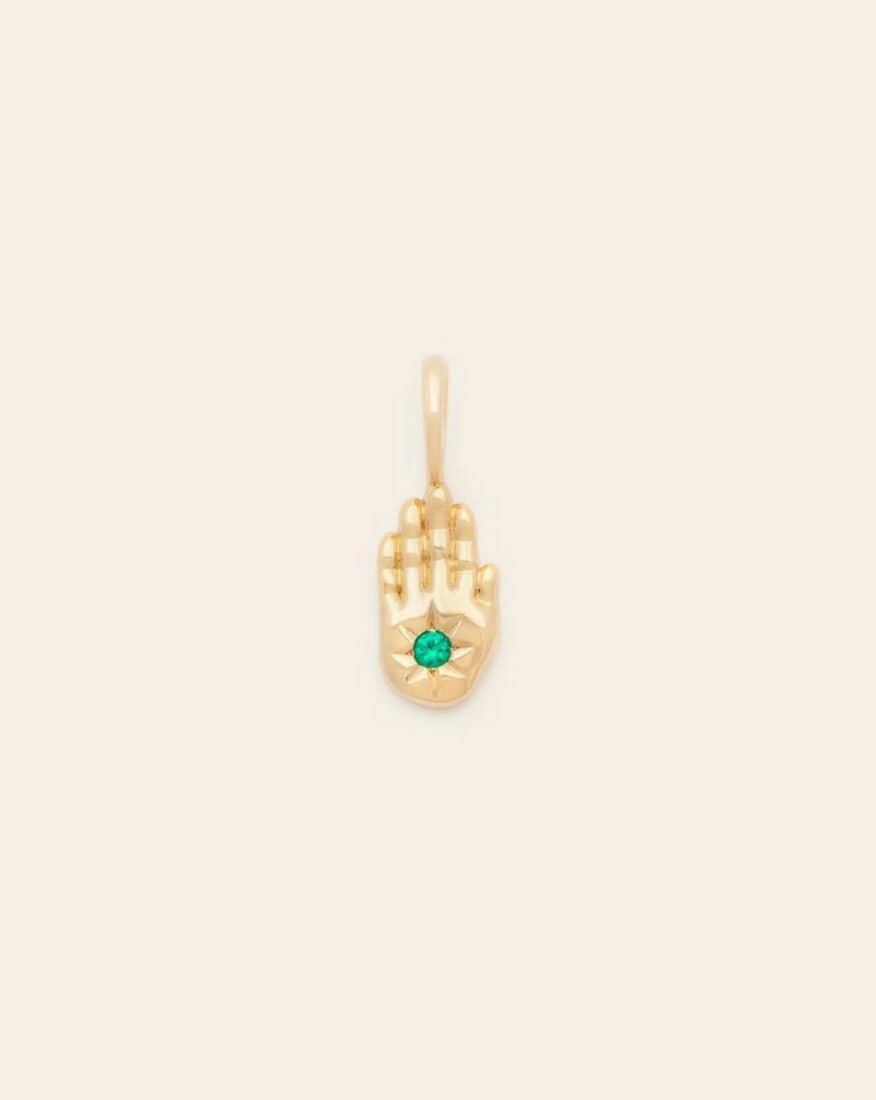 Emerald Hamsa Pendant Gold Vermeil: Emerald Hamsa PendantGold Vermeil A symbol with ancient roots, wear the Hamsa as a talisman of protection and strength. Crafted in gold vermeil, the gold standard of plated jewelry, it features a