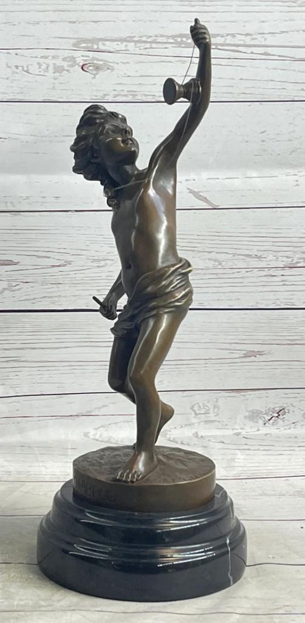 Bronze Sculpture of Playful Boy with Spool Inspired by Goldscheider on Marble Base - 16" x 9.5": Bronze Sculpture of Playful Boy with Spool Inspired by Goldscheider on Marble Base - 16" x 9.5" Immerse yourself in the nostalgic charm of this captivating bronze sculpture that portrays a you
