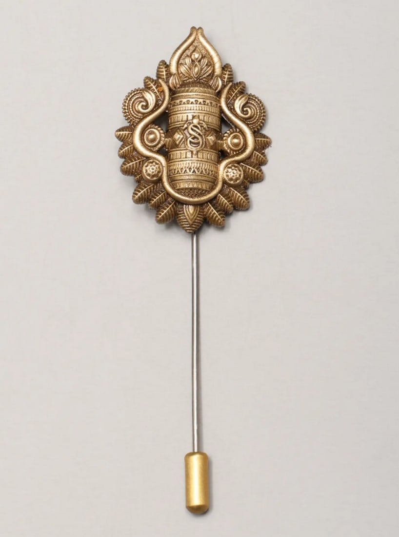 Shiva’s Blessing Lapel Pin: Shiva’s Blessing Lapel Pin Elevate your style with this elegantly crafted lapel pin, featuring a sacred symbol that expresses spirituality and timeless artistry. Made from high-quality brass, the ri
