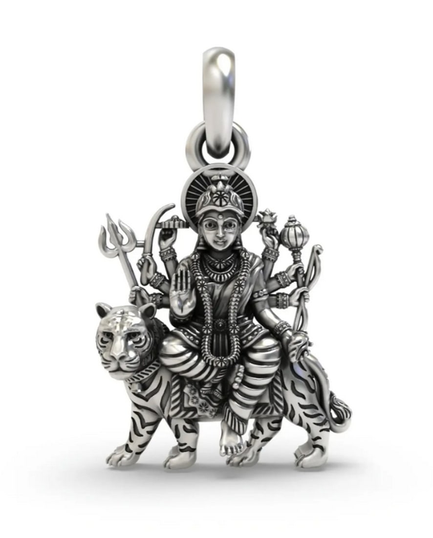Goddess Durga Sterling Silver Pendant: Goddess Durga Sterling Silver Pendant This sterling silver pendant features a detailed depiction of Goddess Durga, symbolizing strength, courage, and divine protection. The finely crafted design
