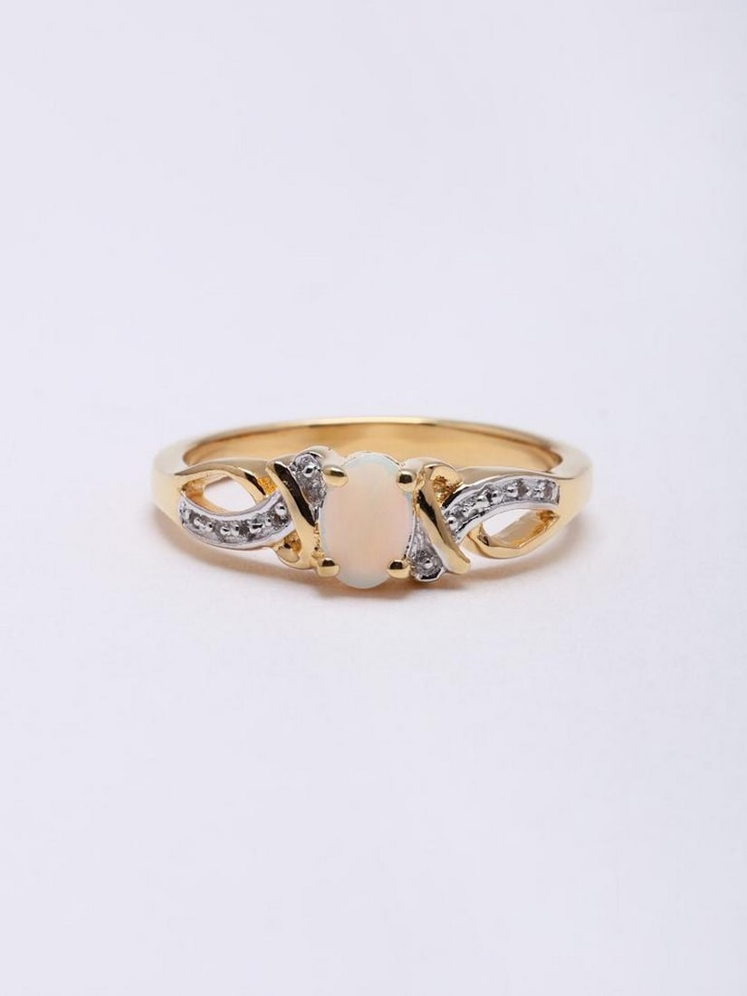 Sterling Silver Ring with Oval Ethiopian Opal: Sterling Silver Ring with Oval Ethiopian Opal This elegant ring features a smooth oval Ethiopian opal set in sterling silver, showcasing the stone’s natural iridescence and subtle play of