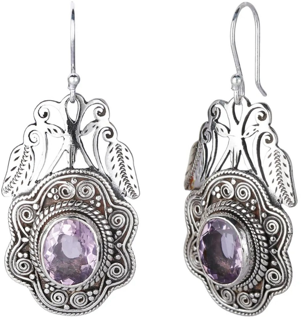 Mystic Glow Oval Earrings: Mystic Glow Oval Earrings These stunning dangle amethyst earrings feature a stylized flower-cut design, accented with sterling silver coils and a chiseled leaf motif. Their rich purple hue adds