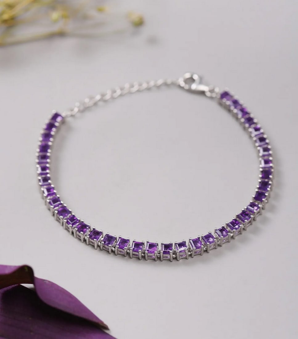 Regal Amethyst Link Bracelet: Regal Amethyst Link Bracelet A sterling silver link bracelet adorned with square-cut faceted amethyst stones. Elegant and timeless, perfect for adding a regal touch to any look. Material: Sterling S