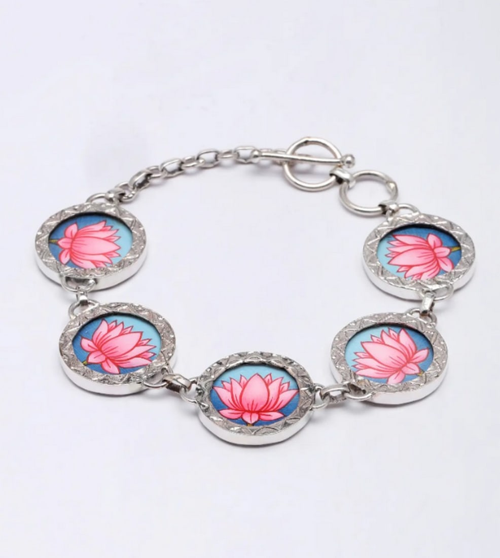 Ethereal Lotus Silver Bracelet: Ethereal Lotus Silver Bracelet This hand-painted sterling silver bracelet is a true work of art, showcasing vibrant lotus flowers against a serene blue backdrop. The rich colors and delicate shading