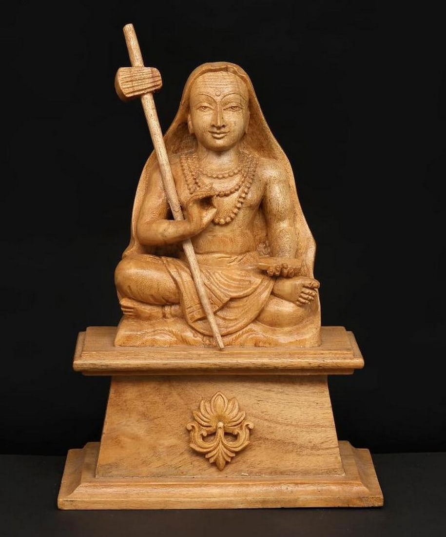 8" Adi Guru Shankaracharya Wood Carving: 8" Adi Guru Shankaracharya Wood Carving This finely handcrafted wooden sculpture depicts Adi Guru Shankaracharya, the revered 8th-century Hindu philosopher and spiritual leader. Carved from high-