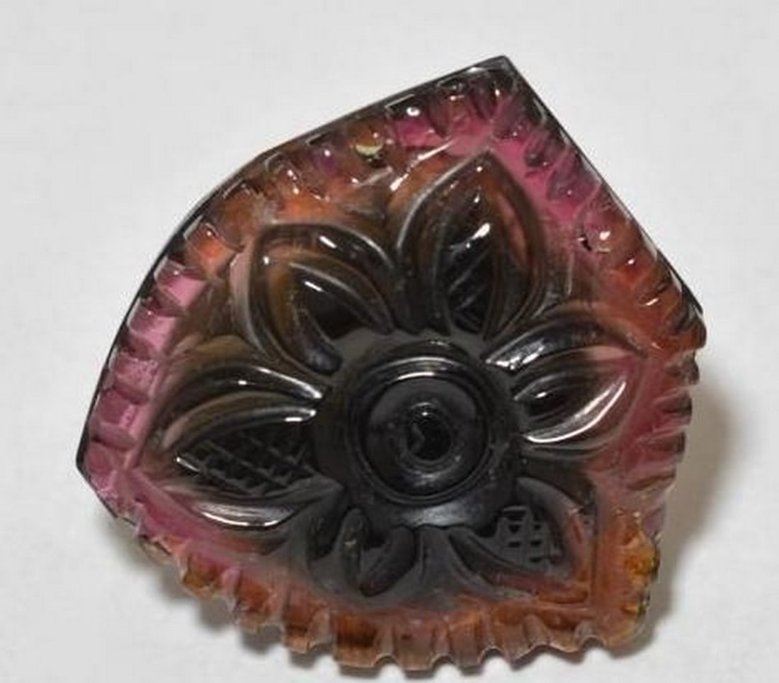 Multicolor Tourmaline Carved Flower Gemstone: Multicolor Tourmaline Carved Flower Gemstone This unique loose gemstone is carved from multicolored tourmaline, featuring a striking blend of deep red, rich purple, and hints of warm orange. Set with
