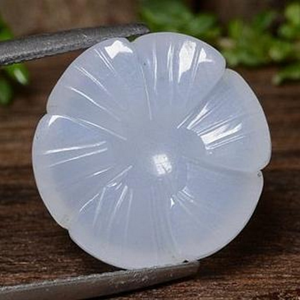 Violet Blue Chalcedony Carved Flower Gemstone: Violet Blue Chalcedony Carved Flower Gemstone This enchanting loose gemstone is delicately carved into the shape of a flower from smooth, translucent violet blue chalcedony. The soft, ethereal hue