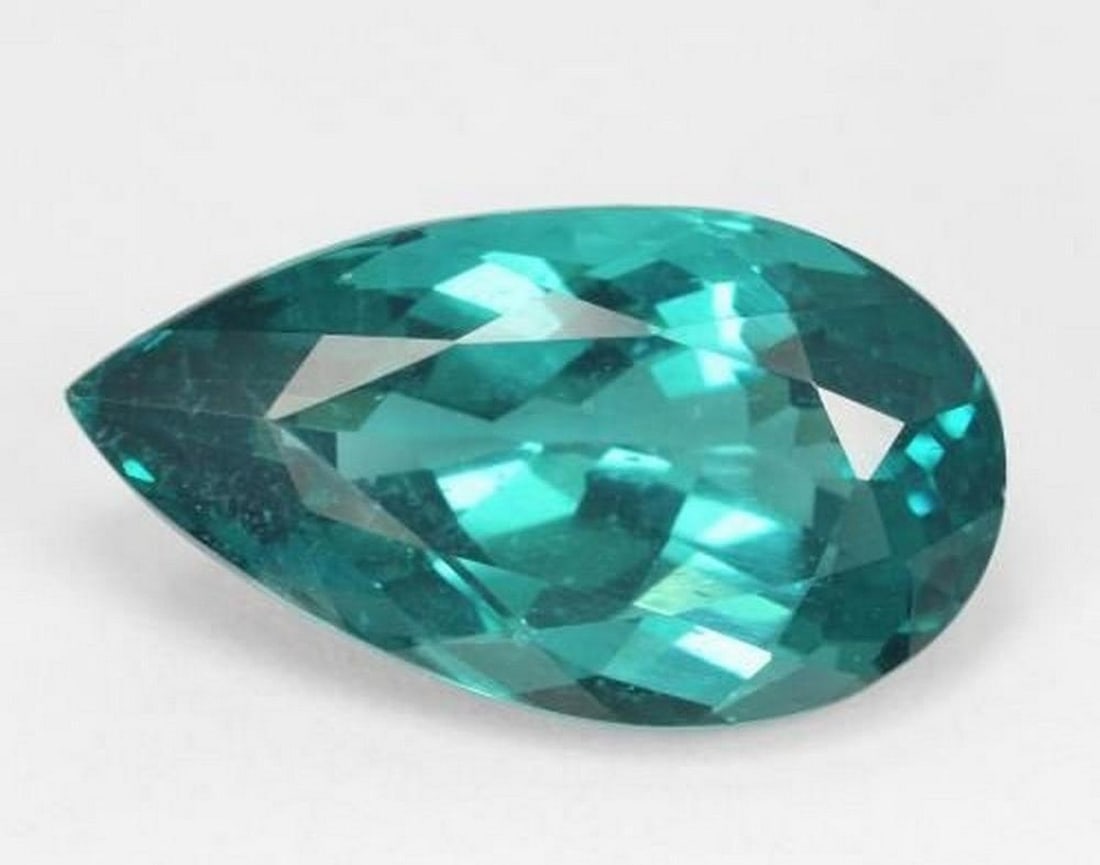 8.62 ct Paraiba-Color Apatite, Pear Facet, VS, Madagascar: 8.62 ct Paraiba-Color Apatite, Pear Facet, VS, Madagascar Natural apatite weighing 8.62 carats, cut in a pear-shaped faceted form with a vivid dark green-blue Paraiba-style color. The gemstone