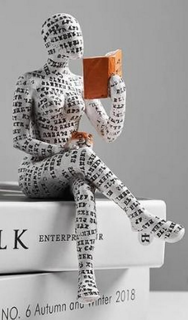 The Reader: Scripted Figure with Cat Sculpture: The Reader: Scripted Figure with Cat Sculpture A quiet moment captured in expressive form, this sculpture features a cross-legged human figure entirely cloaked in white, with black handwritten script