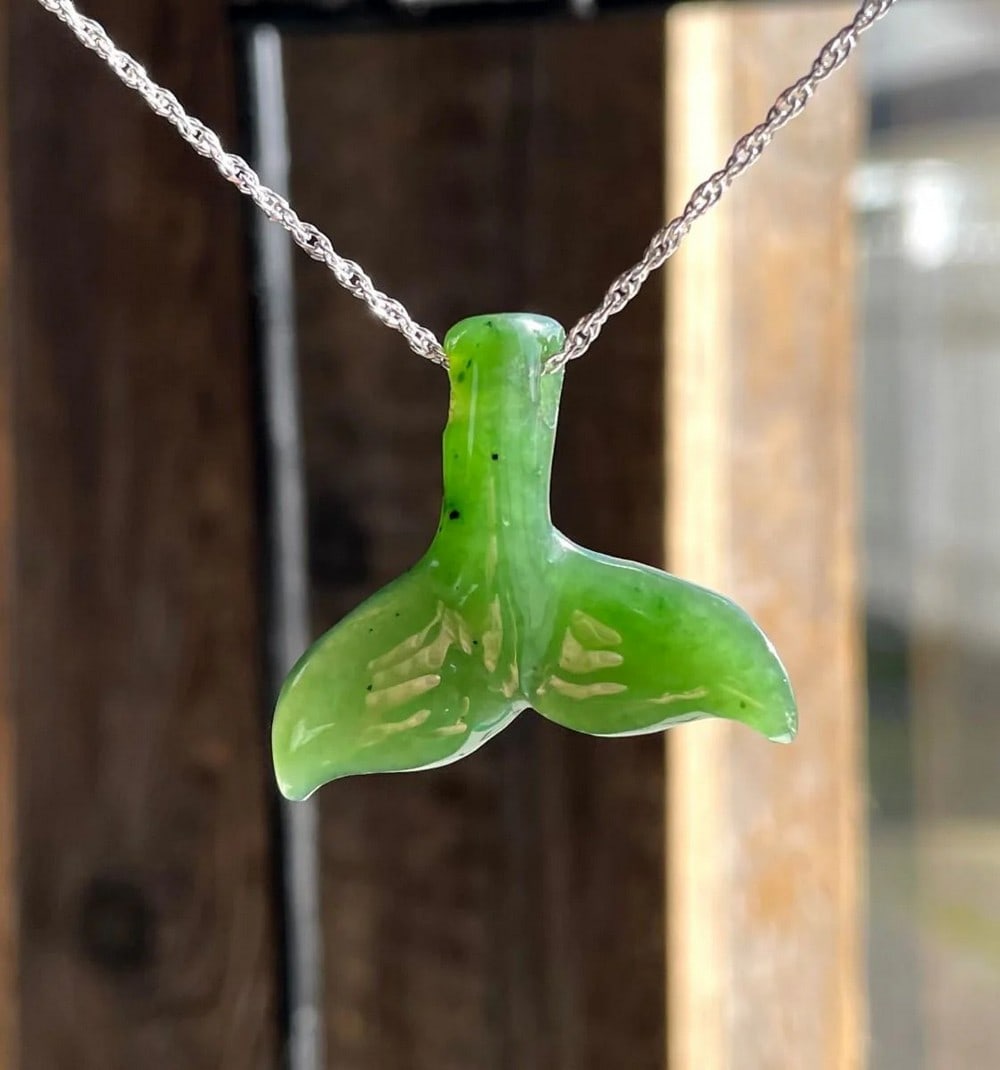 Canadian Nephrite Jade Whale Tail Pendant: Canadian Nephrite Jade Whale Tail Pendant The Canadian Nephrite Jade Whale Tail Pendant is a refined piece of jewelry, expertly hand-carved from authentic Canadian Nephrite Jade into a distinctive