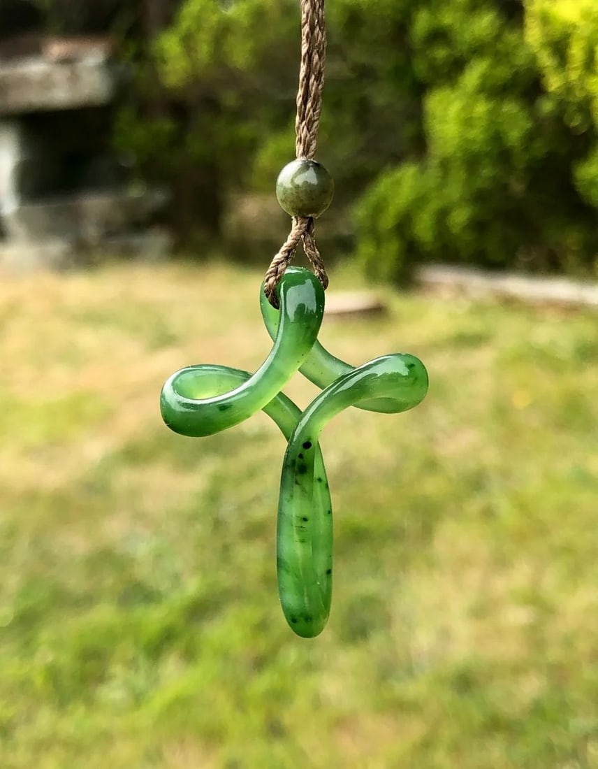 Canadian Nephrite Jade Cross Pendant: Canadian Nephrite Jade Cross Pendant This pendant is hand-carved from genuine Canadian Nephrite Jade, shaped into a traditional cross design that represents faith and strength. The polished finish