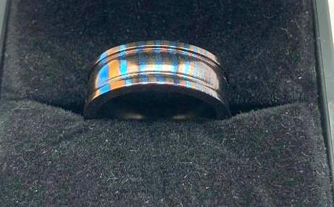 Timascus Ring Blue & Orange Swirl with Dual Indented Line Detail: Timascus Ring Blue & Orange Swirl with Dual Indented Line Detail Bold, vibrant, and truly one-of-a-kind, this Timascus ring features mesmerizing blue and orange swirls that flow organically acros