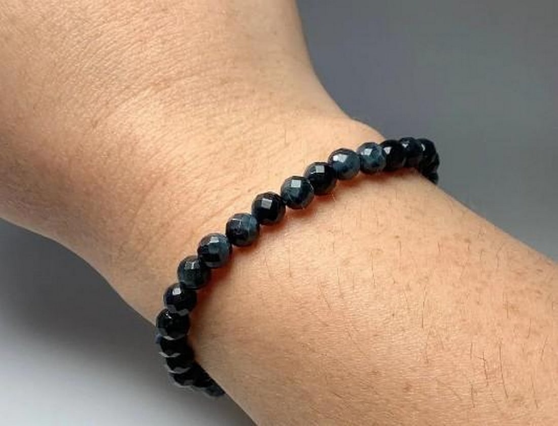 Mystic Blue Tiger Eye Beaded Bracelet: Mystic Blue Tiger Eye Beaded Bracelet The Mystic Blue Tiger Eye Beaded Bracelet features stunning faceted blue tiger eye beads, known for their captivating shimmer and deep, calming hues. Blue