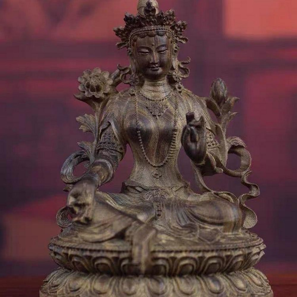 Antique Hand-Carved Natural Indonesian Agarwood Green Tara Guanyin Bodhisattva Statue: Antique Hand-Carved Natural Indonesian Agarwood Green Tara Guanyin Bodhisattva Statue This antique hand-carved statue of Green Tara Guanyin Bodhisattva is crafted from natural Indonesian agarwood, kn