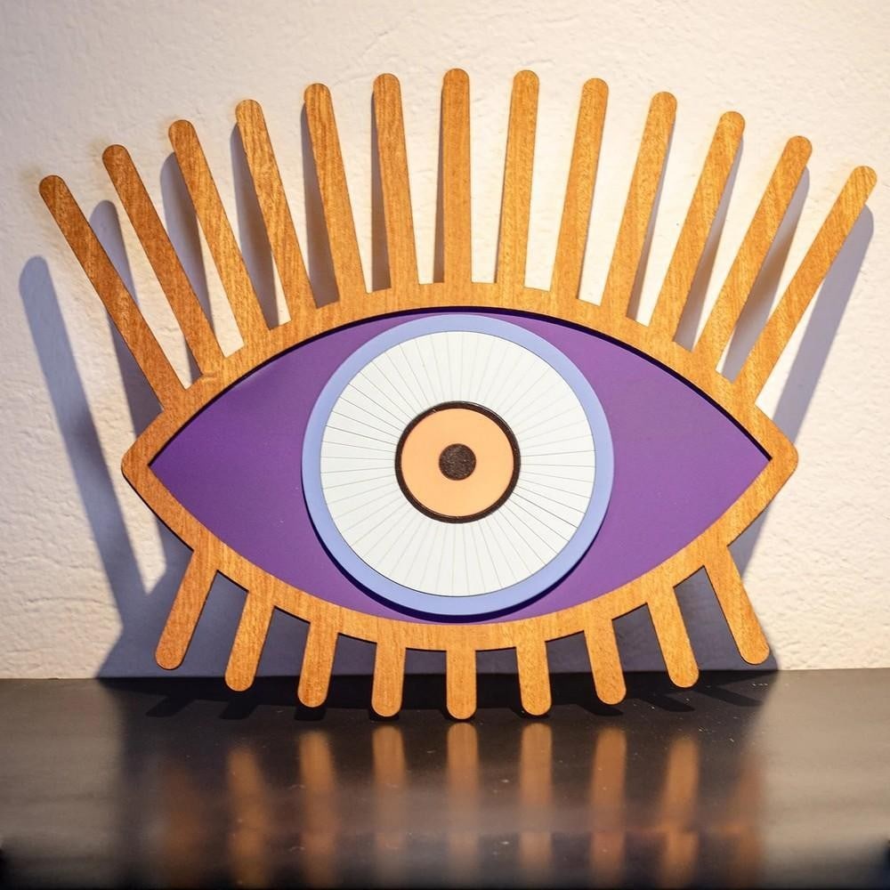 Hand Carved "All Seeing Eye" Wall Art: Hand Carved "All Seeing Eye" Wall Art Picture this striking mask adorning your wall, turning it into a masterpiece of artistic expression. Every carved detail and flowing contour reflects th