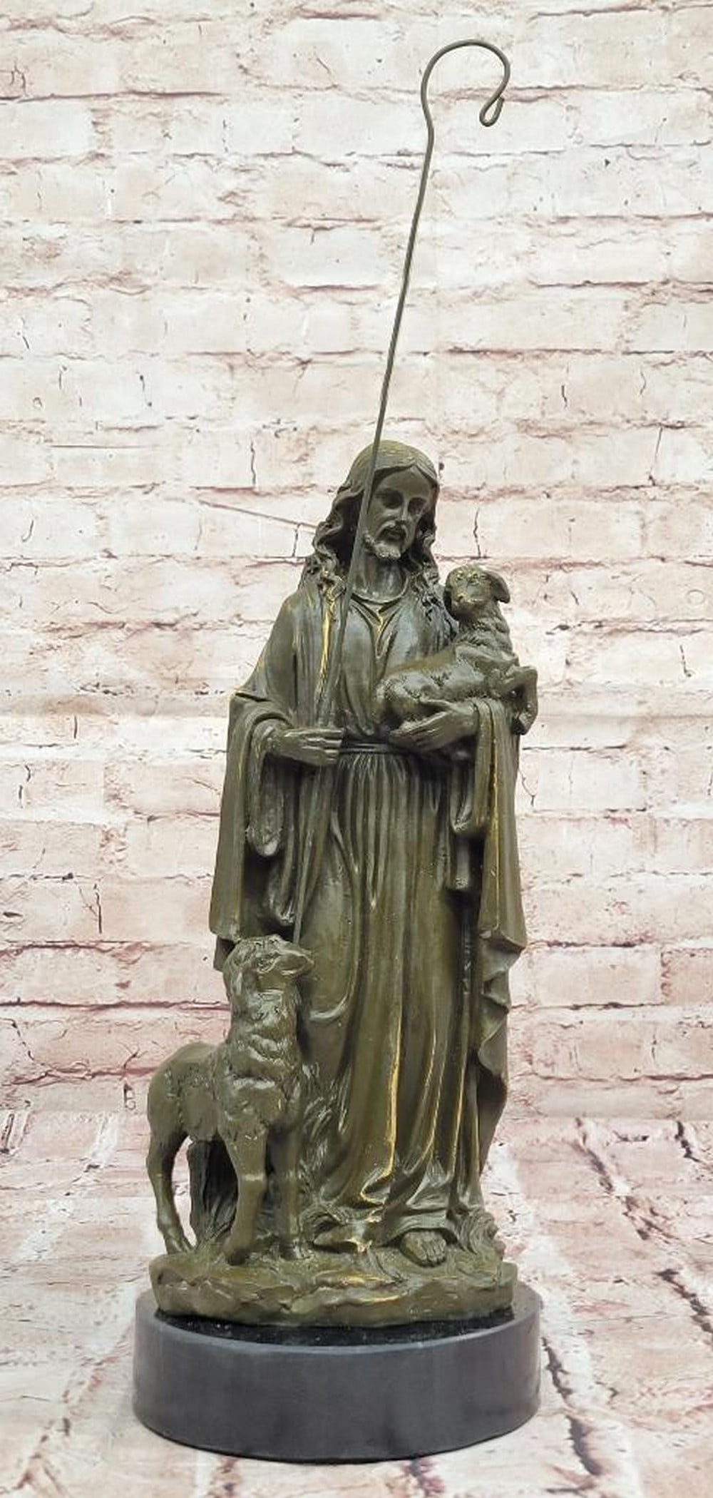 Jesus as Shepherd with Lambs Bronze Sculpture – 13.5" x 5.5": Jesus as Shepherd with Lambs Bronze Sculpture – 13.5" x 5.5" This sculpture depicts Jesus tenderly holding a lamb, symbolizing His role as the Good Shepherd caring for His flock. The detail