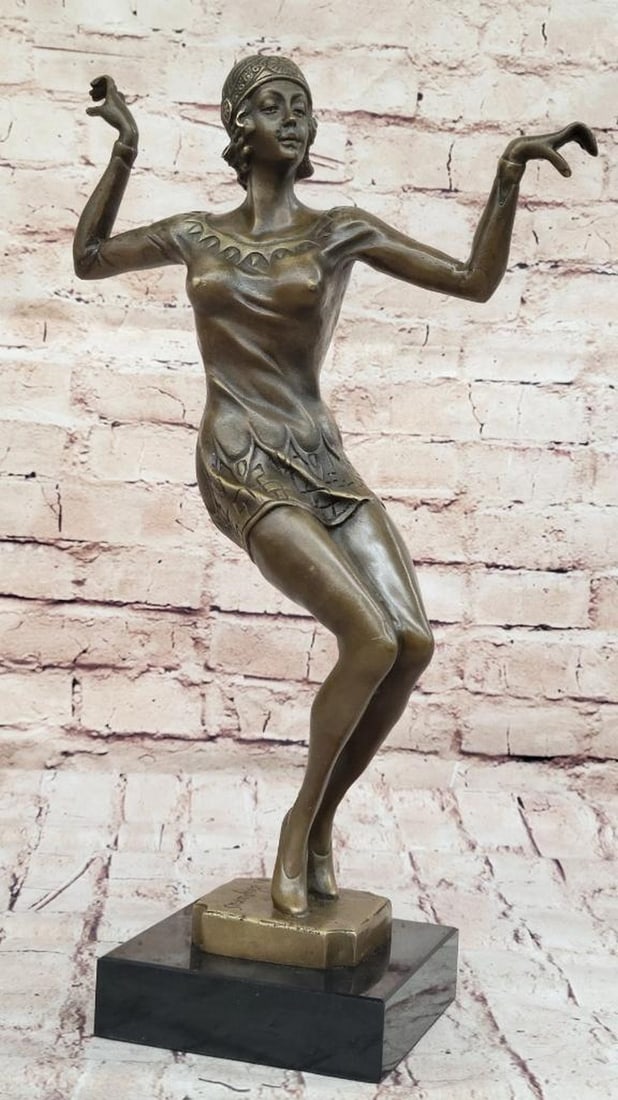 Roaring 50's Dancer Inspired Bronze Statue - 16" x 10": Roaring 50's Dancer Inspired Bronze Statue - 16" x 10" This elegant bronze sculpture captures a dancer’s grace as she balances on her toes, arms extended. Her short dress highlights he