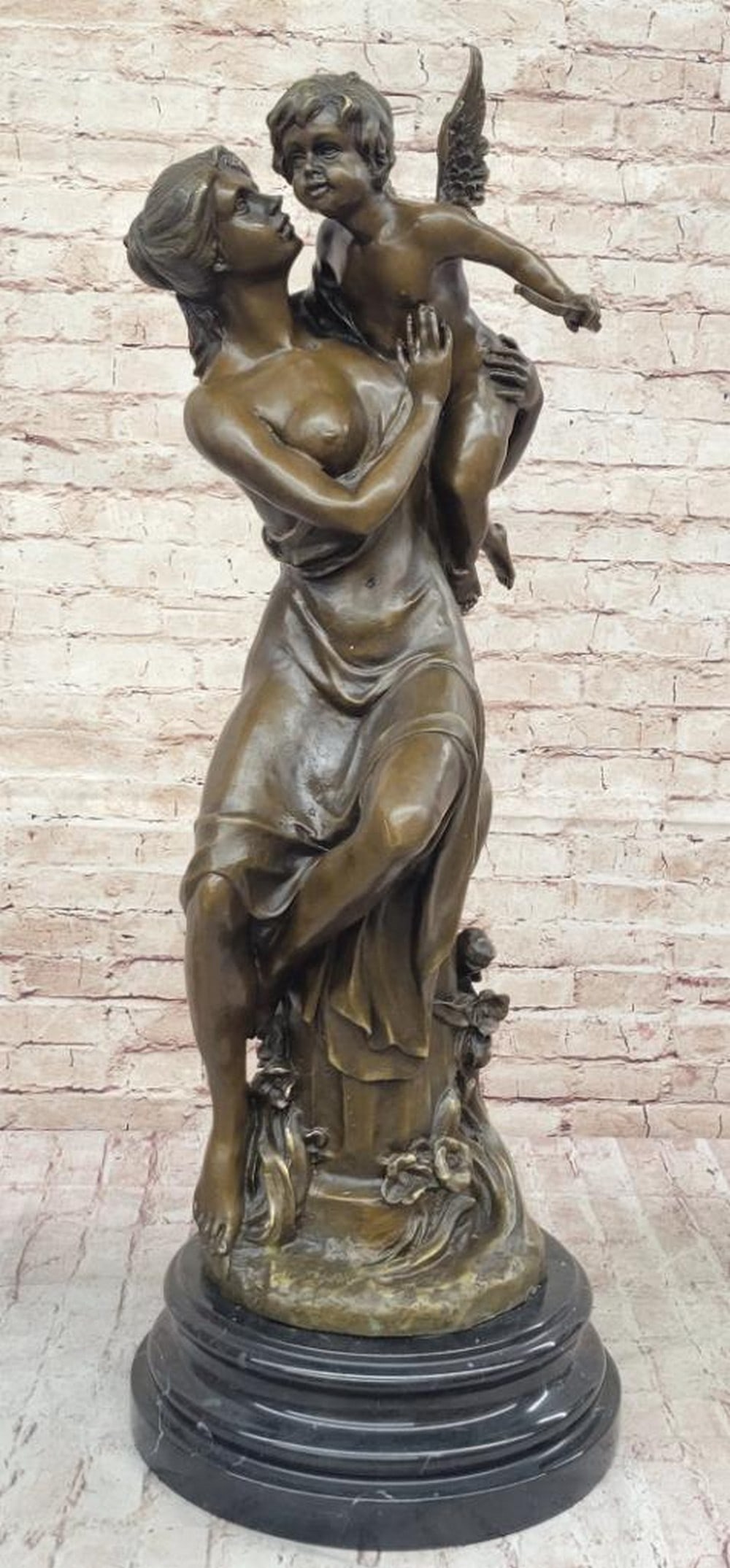 Maternal Grace Bronze Sculpture by Milo - 32" x 12": Maternal Grace Bronze Sculpture by Milo - 32" x 12" This stunning bronze sculpture by Milo captures a serene moment of maternal devotion. A graceful woman sits atop an ornate column, cradling