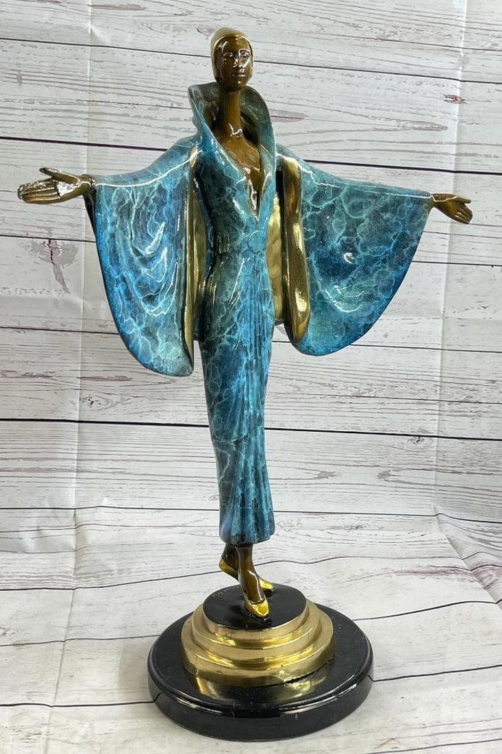 Colourful Showgirl Inspired Bronze Sculpture: Colourful Showgirl Inspired Bronze Sculpture She stands at the end of the runway. The camera bulbs flash as she spreads her arms to showcase her fashion forward outfit. She wears a long golden brown