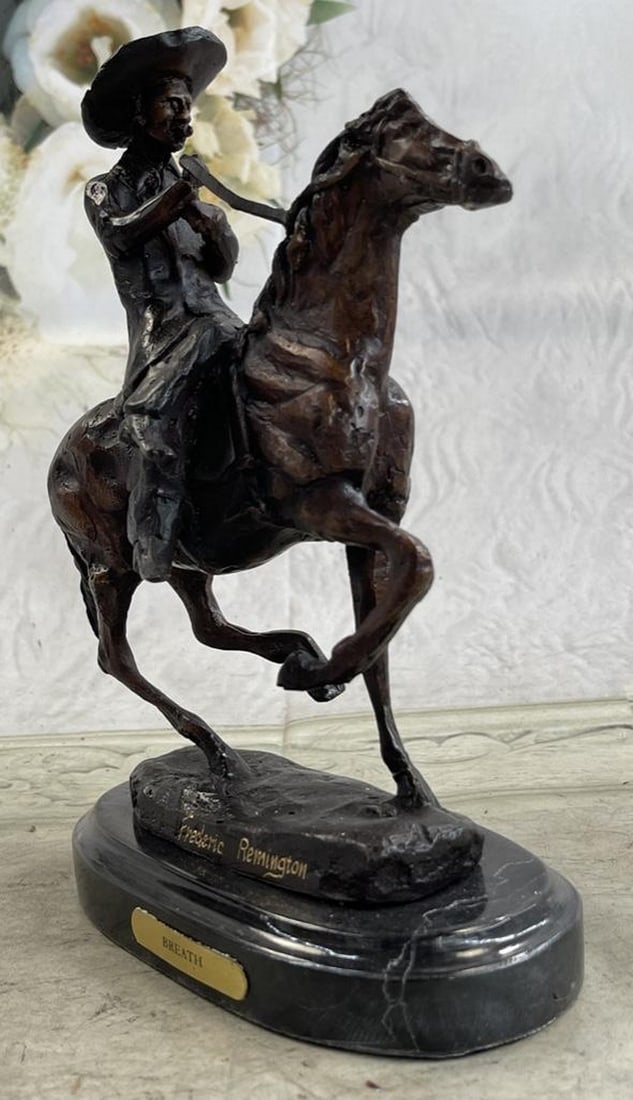 Bronze Cowboy Sculpture: Bronze Cowboy Sculpture A seasoned cowboy courageously rides his wild horse. He is bucked by his uncontrollable stallion but his grip on the reins never break. His body rolls with every m