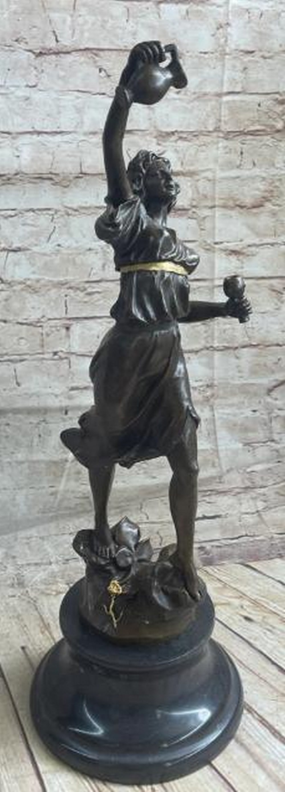 Woman Carrying Water Jug Bronze Sculpture: Woman Carrying Water Jug Bronze Sculpture A classical bronze sculpture depicting a lady holding a jug and cup of vine. The bronze sculpture was produced using the lost-wax technique allow