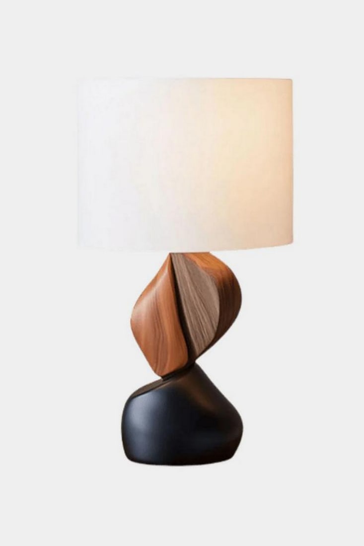 Twisted Form Wooden Table Lamp: Twisted Form Wooden Table Lamp Artful and bold, this handcrafted table lamp features a sculptural base with twisted wood-textured elements in rich brown tones, anchored by a smooth matte black foundat