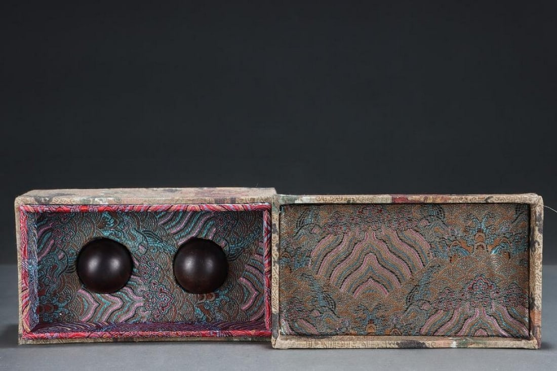 Old Collection Agarwood Carving Handball Pair: Old Collection Agarwood Carving Handball Pair A rare pair of hand-carved agarwood handballs, showcasing the natural beauty and rich aroma of high-quality agarwood. Each ball is smoothly polished and e