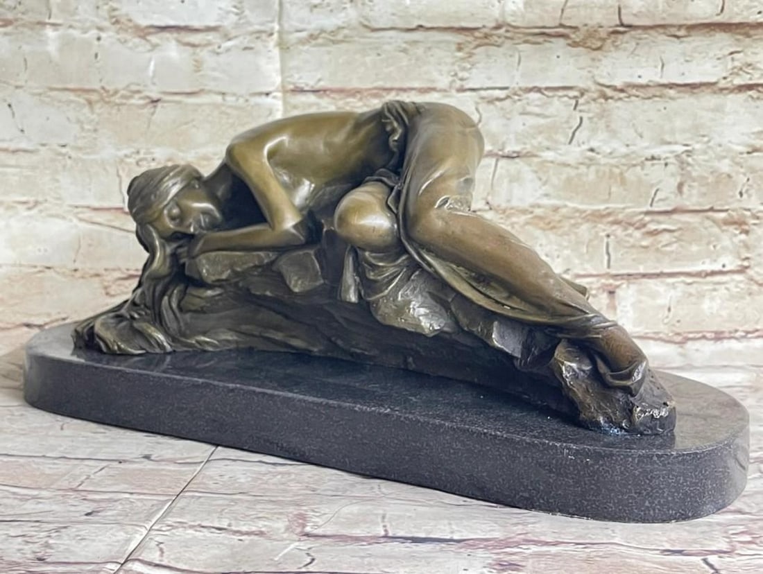 Bronze Sculpture of Reclining Semi-Nude Woman: Bronze Sculpture of Reclining Semi-Nude Woman A striking bronze sculpture depicting a woman in a graceful, semi-nude fetal pose, her form resting upon a textured rock-like base. Mounted on a polished