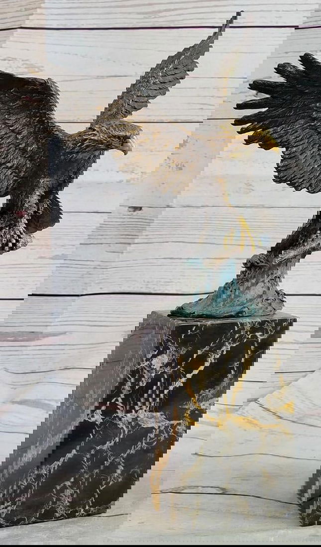 Flying Eagle Catching Fish Bronze Sculpture on Marble Base – 14" x 8": Flying Eagle Catching Fish Bronze Sculpture on Marble Base – 14" x 8" This bronze sculpture captures a majestic eagle perched atop its nest, claws spread and eyes focused, ready to swoop for