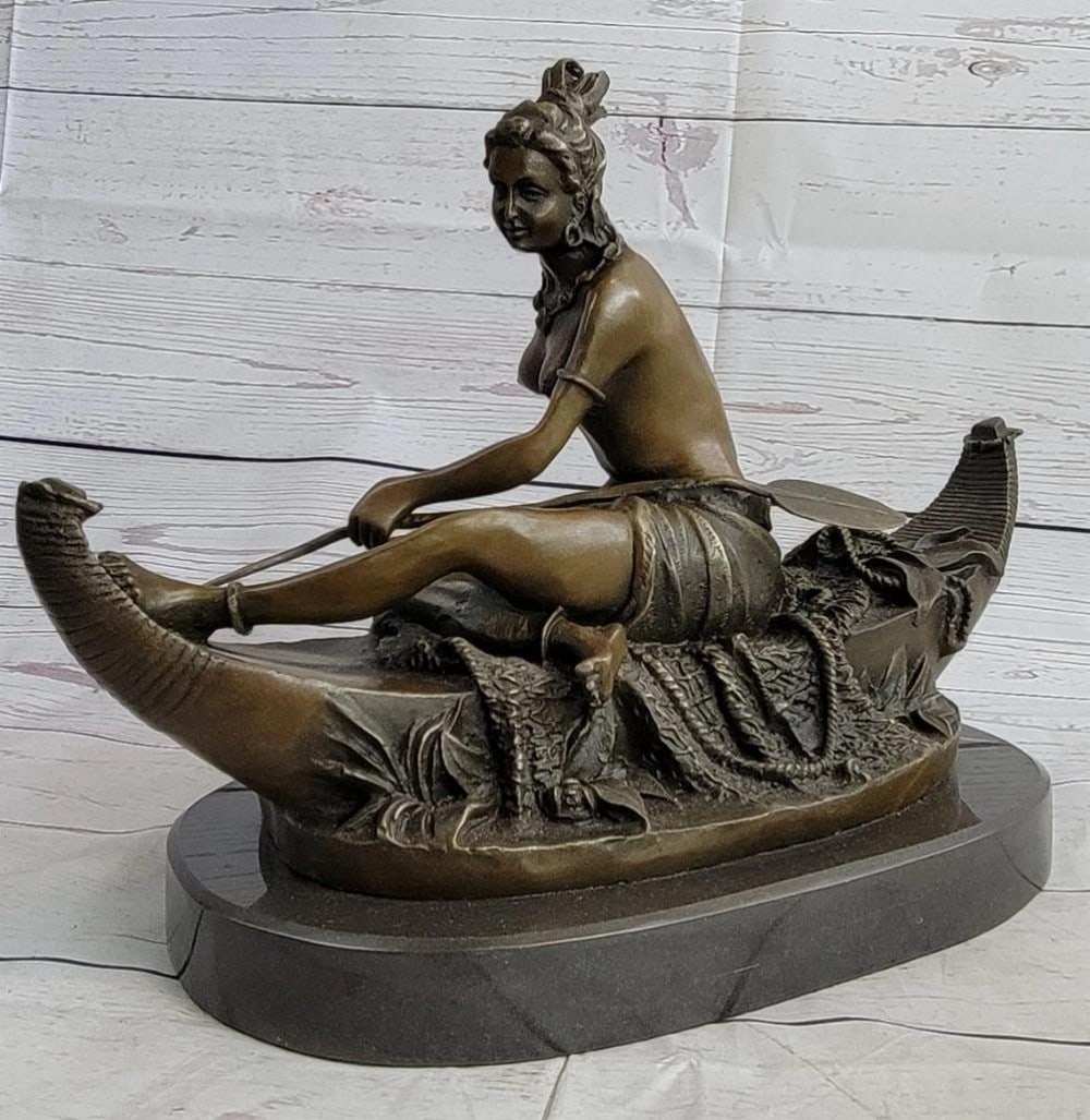 Native American Canoeing Woman Bronze Sculpture: Native American Canoeing Woman Bronze Sculpture This Native American woman sits down on her personal boat, she gracefully relaxes in the middle of the water with her paddle at hand for any emergency.