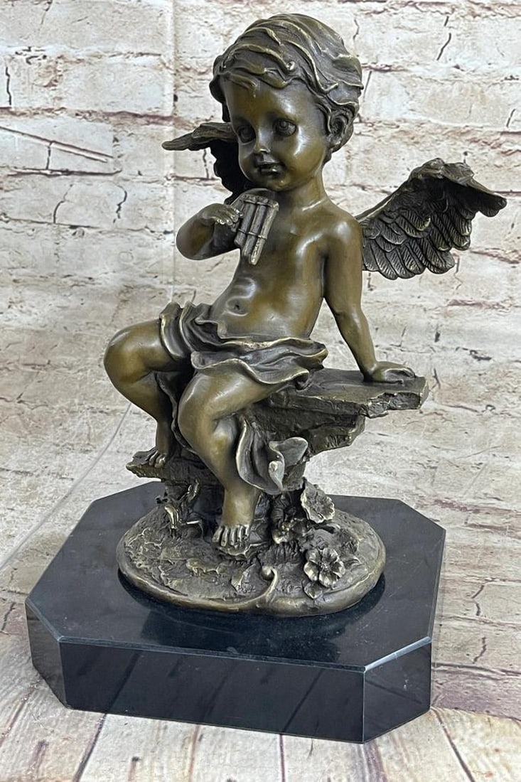 Cherub Angel Bronze Sculpture: Cherub Angel Bronze Sculpture This beautiful bronze statue depicts an adorable little cherub playing the pan Flute. It is part of a series of cherub musicians and would look equally good inside your