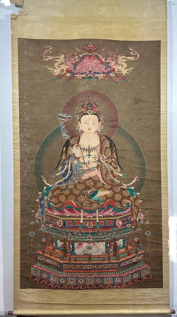 Divine Presence Inspired Scroll Painting by Ding Yunpeng: Divine Presence Inspired Scroll Painting by Ding Yunpeng This monumental handpainted silk scroll, inspired by the sacred artistry of Ding Yunpeng, features a majestic deity seated in lotus posture ato