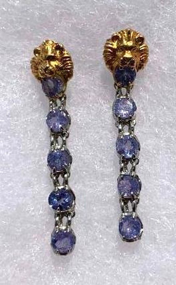 Round Blue Tanzanite 4mm Lion Earrings: Round Blue Tanzanite 4mm Lion Earrings Add a touch of regal elegance to your look with these stunning lion earrings, featuring 4mm round blue tanzanite stones set in sterling silver. The deep, rich