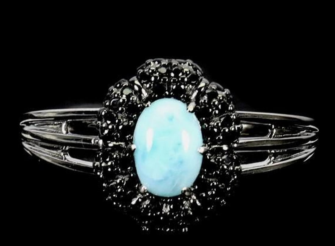 Sterling Silver Oval Larimar & Spinel Ring: Sterling Silver Oval Larimar & Spinel Ring This elegant 925 sterling silver ring features a 7x5mm oval Larimar gemstone, known for its tranquil blue tones reminiscent of tropical waters, accented