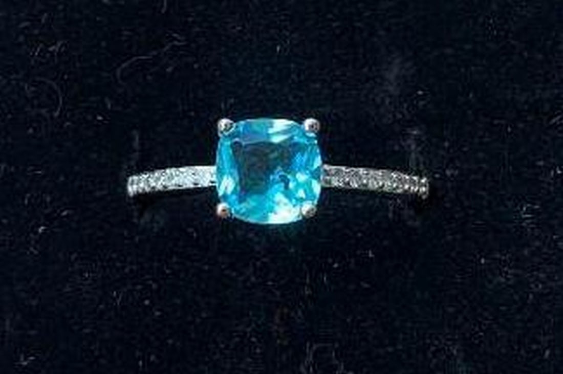 Sterling Silver Cushion-Cut Light Blue Stone Ring: Sterling Silver Cushion-Cut Light Blue Stone Ring Crafted in sterling silver, this exquisite ring showcases a cushion-cut light blue stone, radiating a serene and soothing aura. The stone is beautifu