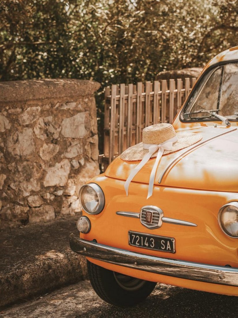 Seaside Drive Poster: Seaside Drive Poster A poster featuring a vintage orange car parked in the sun with a straw hat resting on the hood. The warm tones and nostalgic details capture a relaxed coastal atmosphere with a