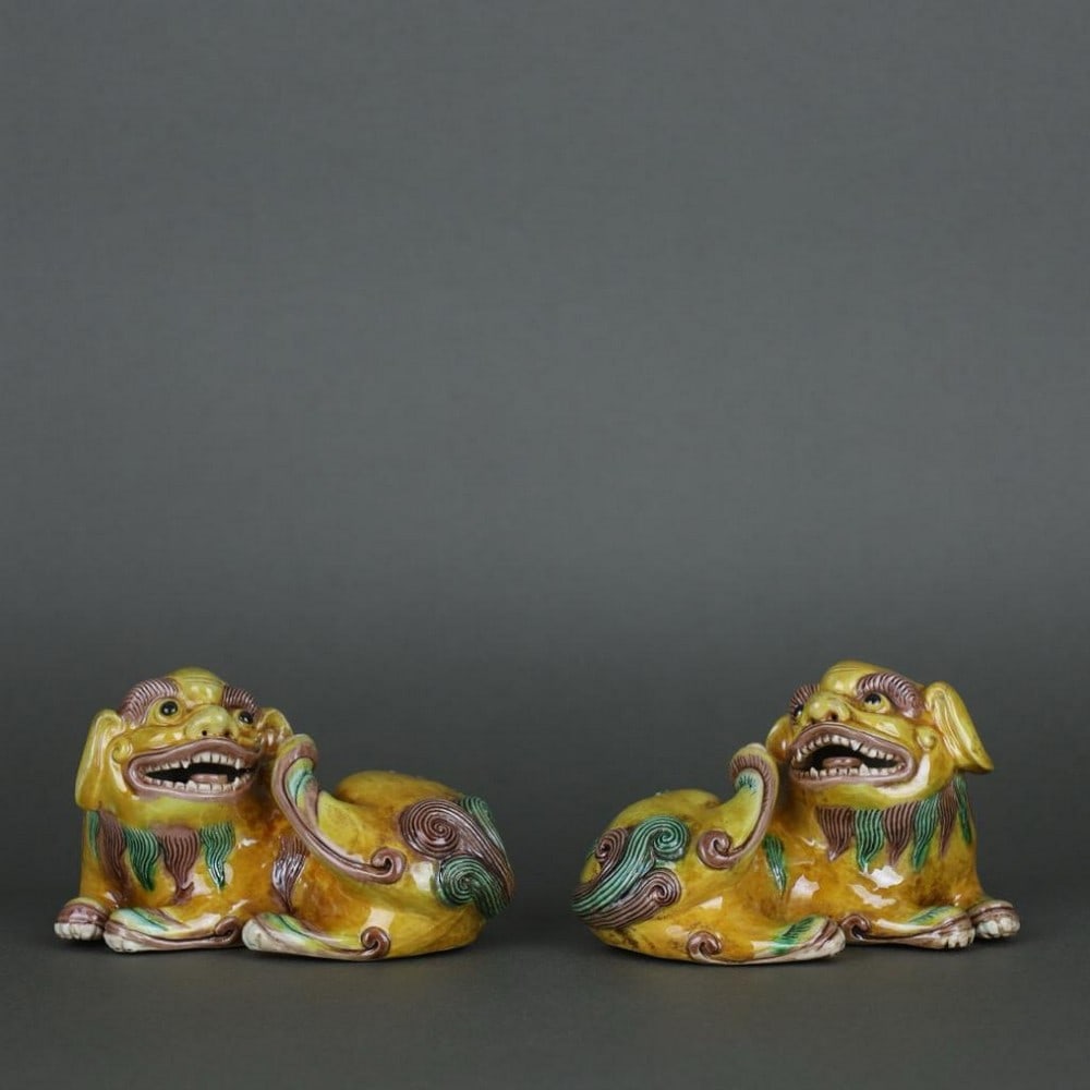 Qing Dynasty Three-Color Lion Ornament: Qing Dynasty Three-Color Lion Ornament A finely crafted lion ornament from the Qing Dynasty, featuring a vibrant three-color glaze. The piece showcases detailed modeling and expressive features, refle