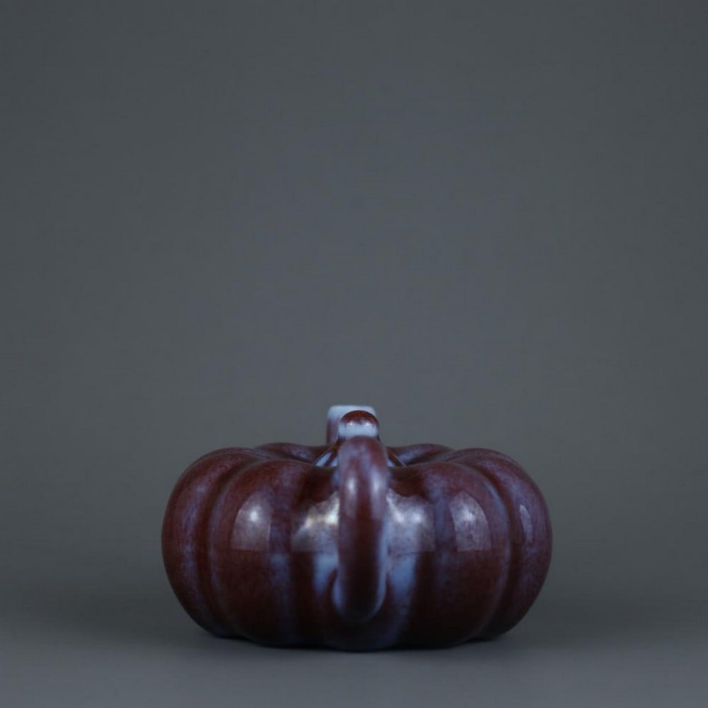 Qing Dynasty Qianlong Glazed Pumpkin-Shaped Pot: Qing Dynasty Qianlong Glazed Pumpkin-Shaped Pot A charming porcelain pumpkin-shaped pot from the Qianlong period of the Qing Dynasty. The vessel is beautifully glazed, emphasizing its naturalistic for