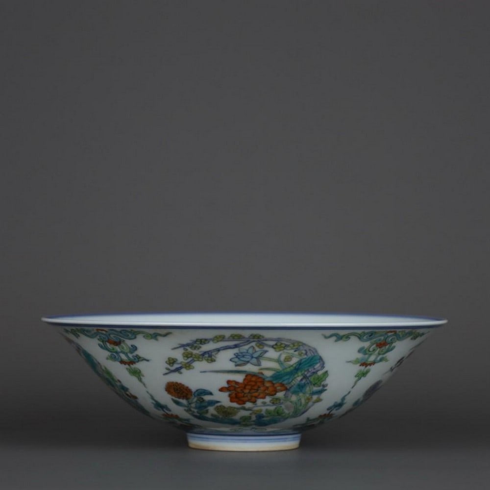 Qing Dynasty Yongzheng Doucai Floral Pattern Hat Bowl: Qing Dynasty Yongzheng Doucai Floral Pattern Hat Bowl A finely crafted hat-shaped porcelain bowl from the Yongzheng period of the Qing Dynasty, exquisitely decorated in the doucai technique. The surfa