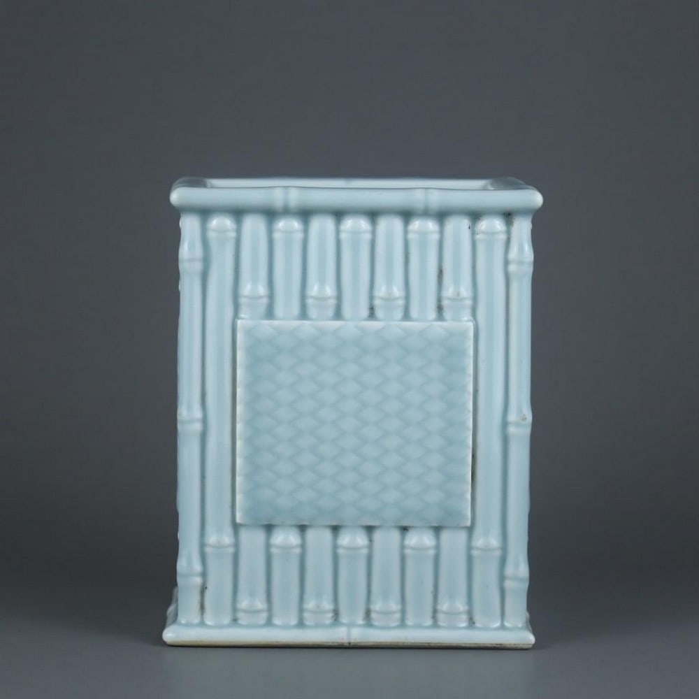 Qing Dynasty Qianlong Sky-Blue Glaze Carved Bamboo Square Pen Holder: Qing Dynasty Qianlong Sky-Blue Glaze Carved Bamboo Square Pen Holder A finely crafted square porcelain pen holder from the Qianlong period of the Qing Dynasty, finished in a soft sky-blue glaze. The s