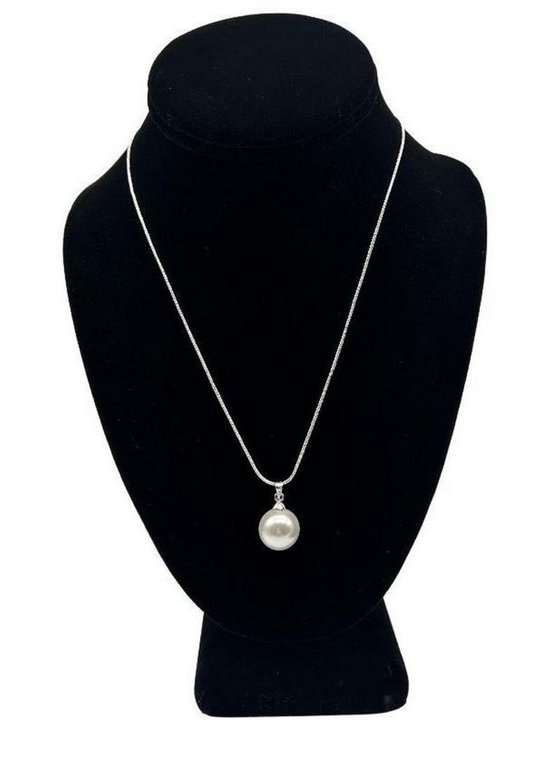 CLASSY WHITE ROUND SHELL PEARL PENDANT ON NECKLACE: Classy White Round Shell Pearl Pendant on Necklace This classic white round shell pearl pendant is on a 925 sterling silver necklace. This timeless shell pearl is perfect for elevating any look or ou