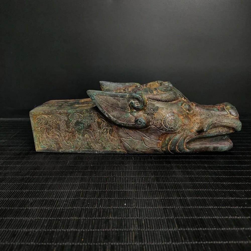 Antique Chinese Animal Head Bronze Statue: Antique Chinese Animal Head Bronze Statue This antique Chinese bronze statue features an intricately crafted animal head, symbolizing power, wisdom, and spiritual significance. The fine detailing and